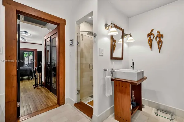 a bedroom with a bed and a mirror