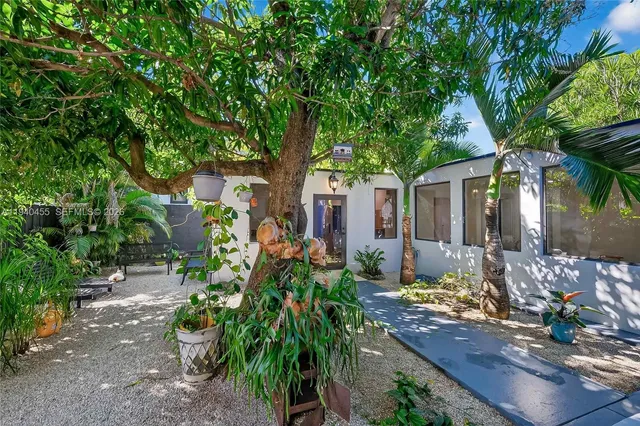front view of a house with a tree