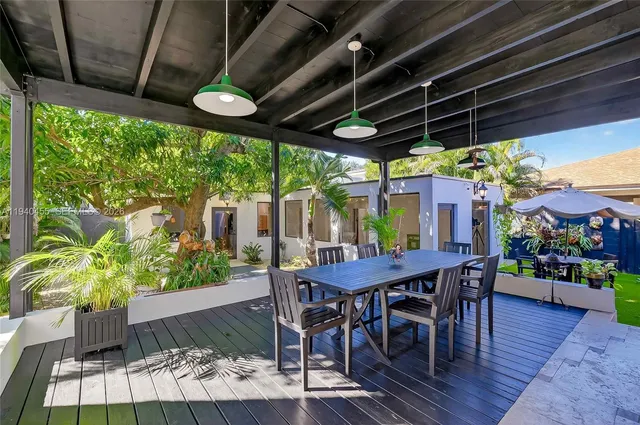 a view of a table and chairs in patio with wooden fence