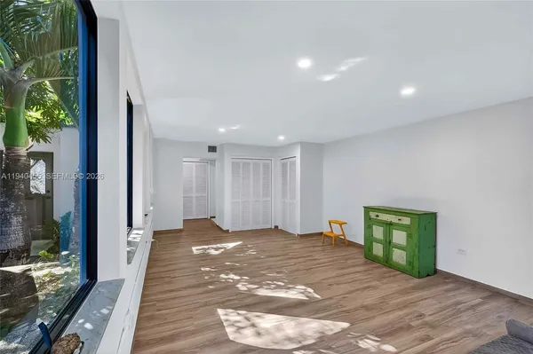 a view of an empty room and a window