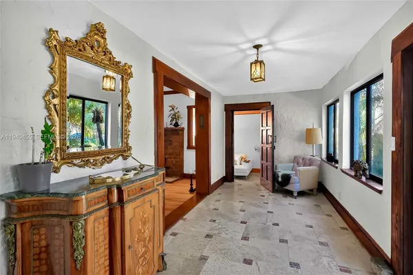 a view of a hallway with furniture and windows