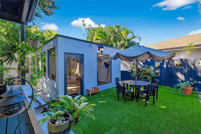 a view of a patio with table and chairs and potted plants