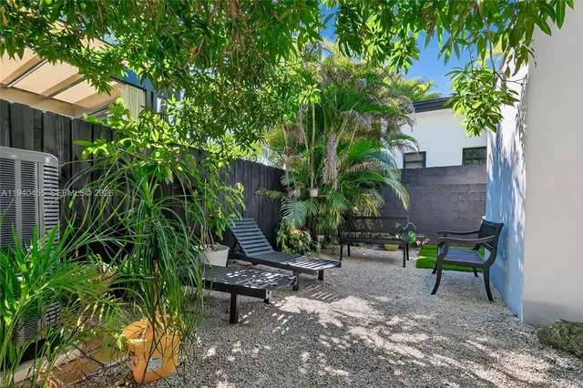 a view of a chairs and table in backyard of the house