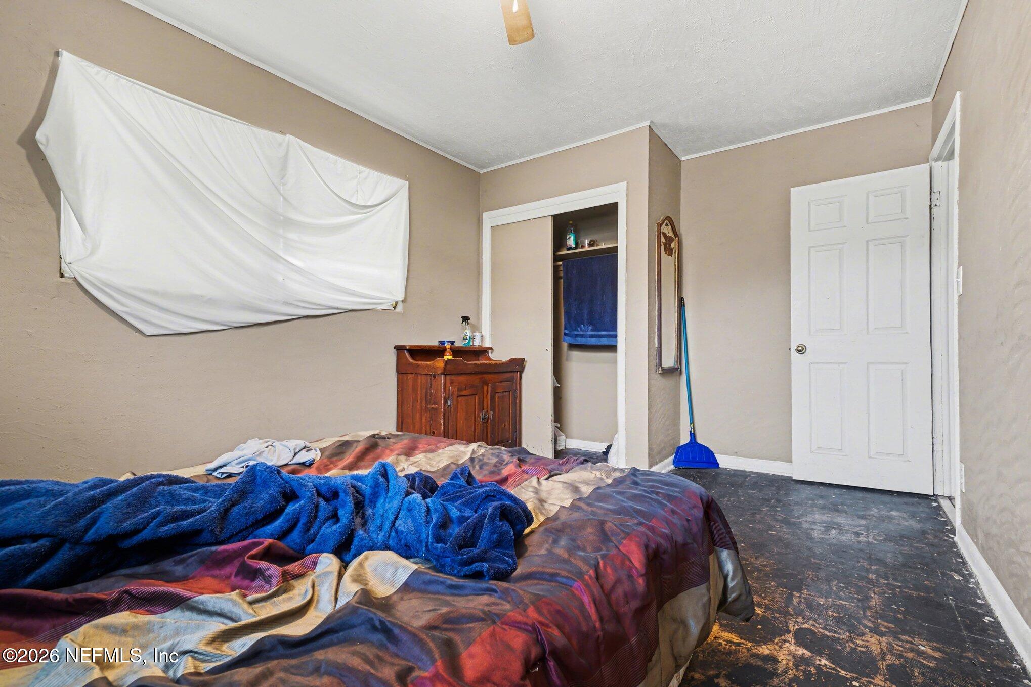 1826 Leon Road Jacksonville, FL 32246 - Photo 14 of 23 a bed room with a bed and a painting on the wall