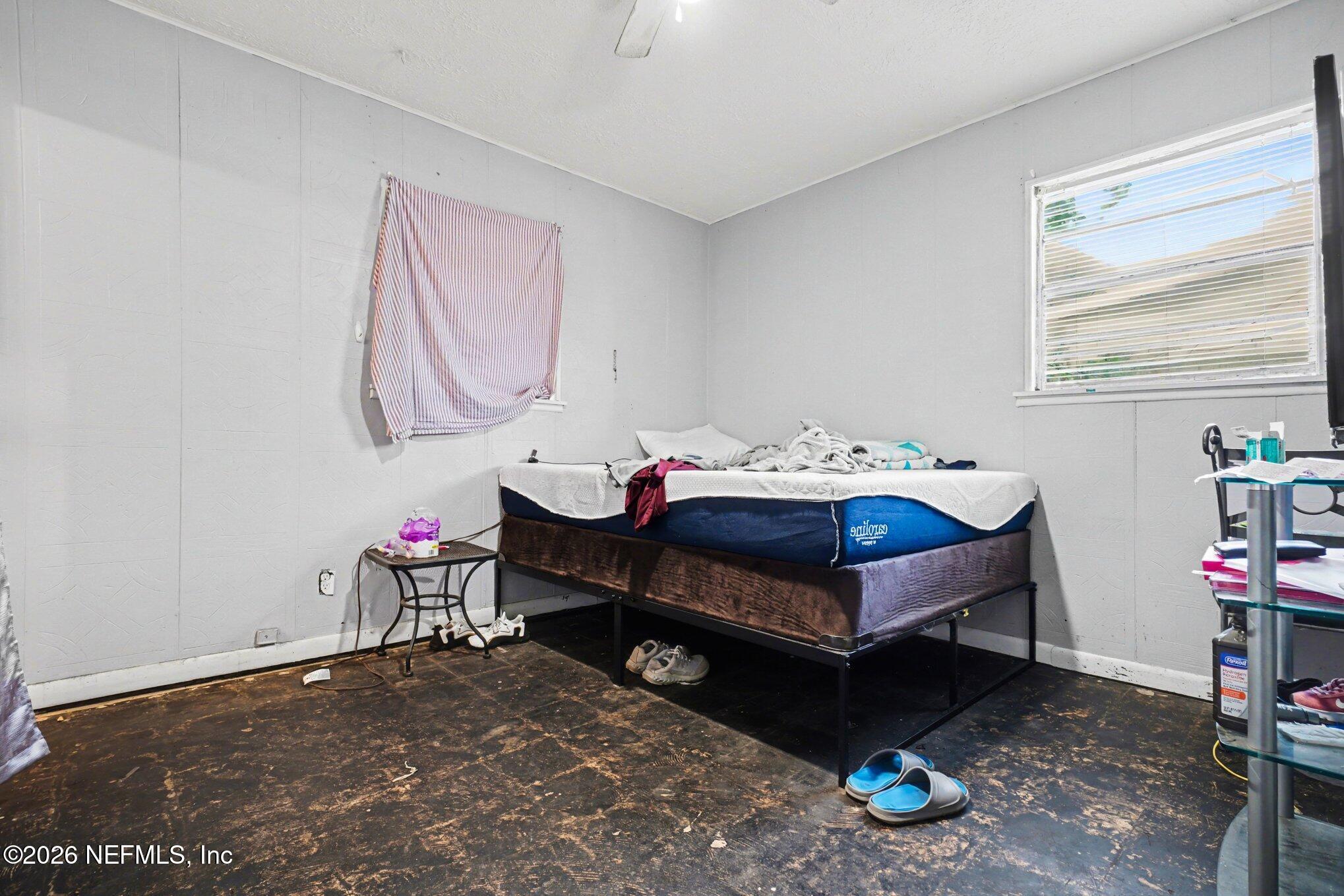 1826 Leon Road Jacksonville, FL 32246 - Photo 15 of 23 a bedroom with a bed and a window