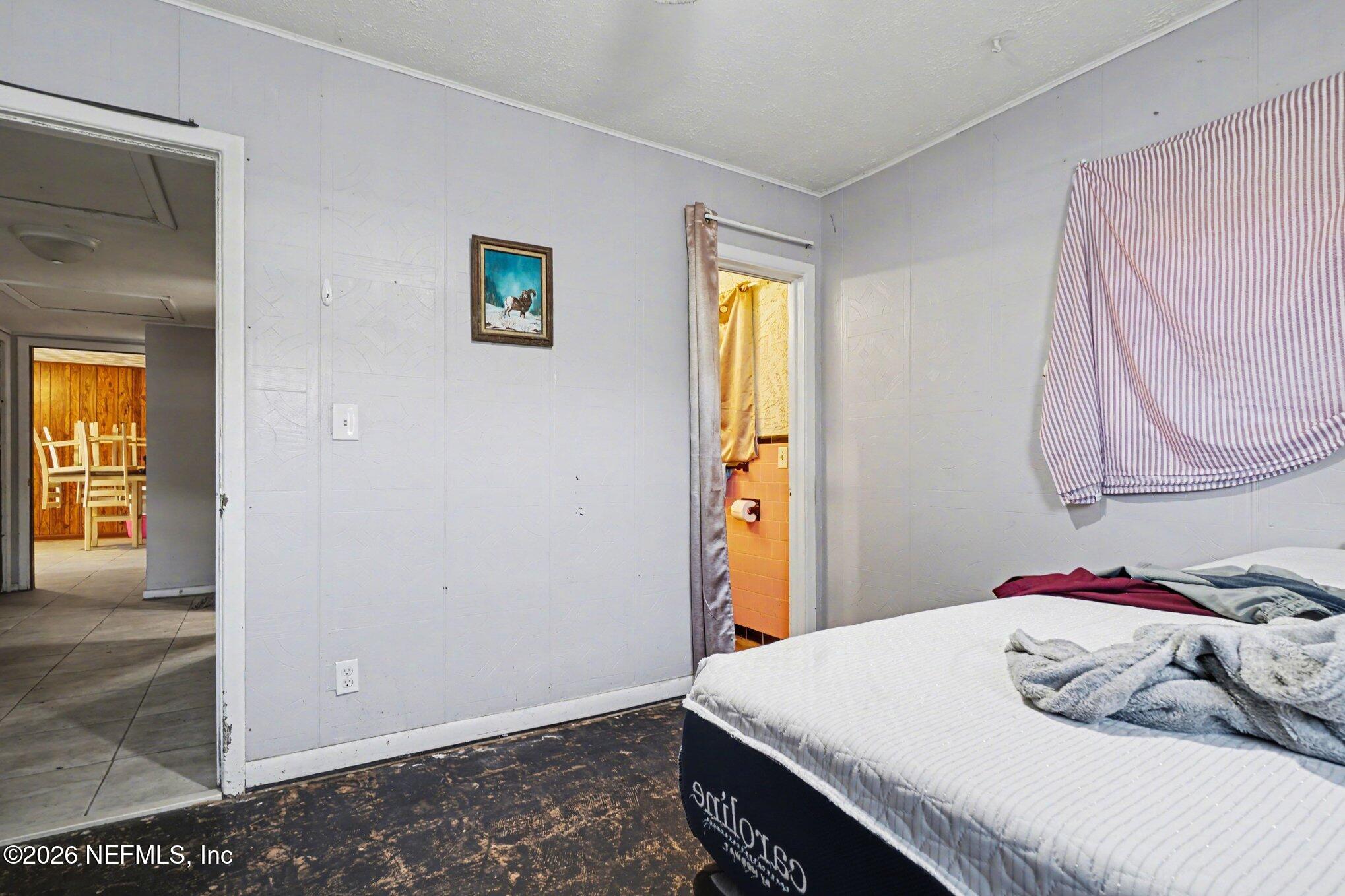 1826 Leon Road Jacksonville, FL 32246 - Photo 16 of 23 a bedroom with a bed and a window