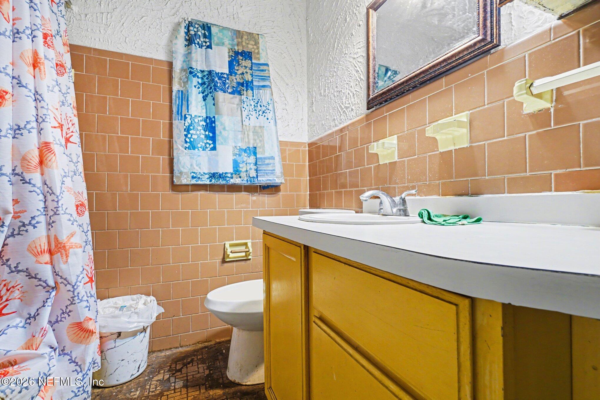 1826 Leon Road Jacksonville, FL 32246 - Photo 20 of 23 a bathroom with a sink mirror toilet and shower