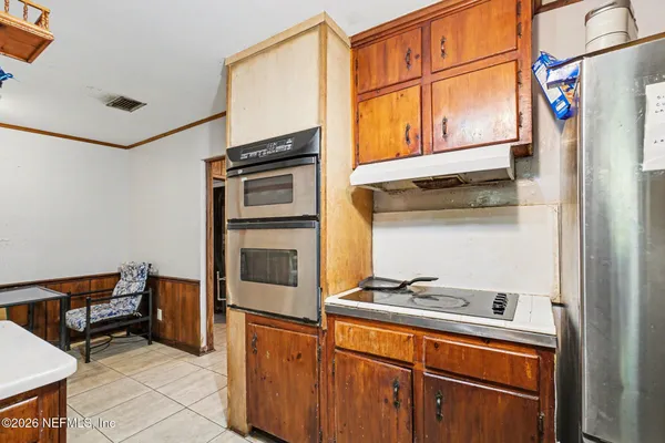 a kitchen with stainless steel appliances granite countertop a refrigerator and a stove top oven