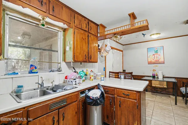 a kitchen with a sink stove and cabinets