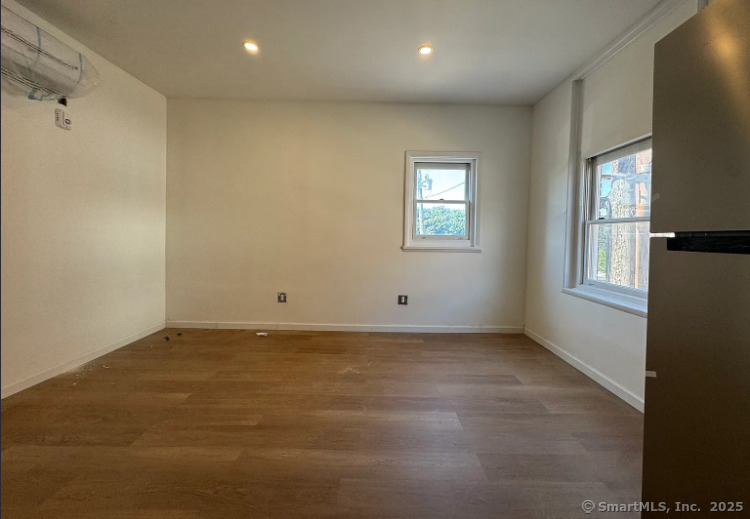 61 Field Street, Unit 104 Waterbury, CT 06702 - Photo 3 of 12 an empty room with windows