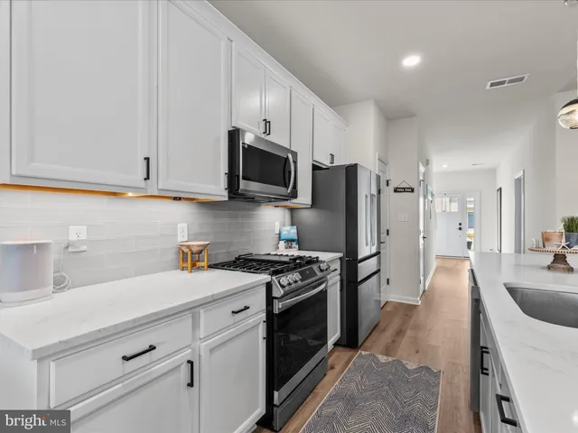 a kitchen with a sink a stove and refrigerator