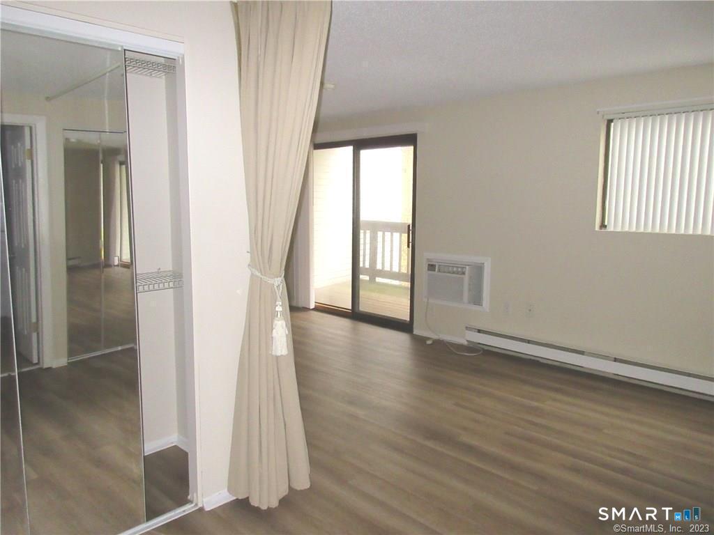 5 Nabby Road, Unit A51 Danbury, CT 06811 - Photo 8 of 13 an empty room with wooden floor and windows