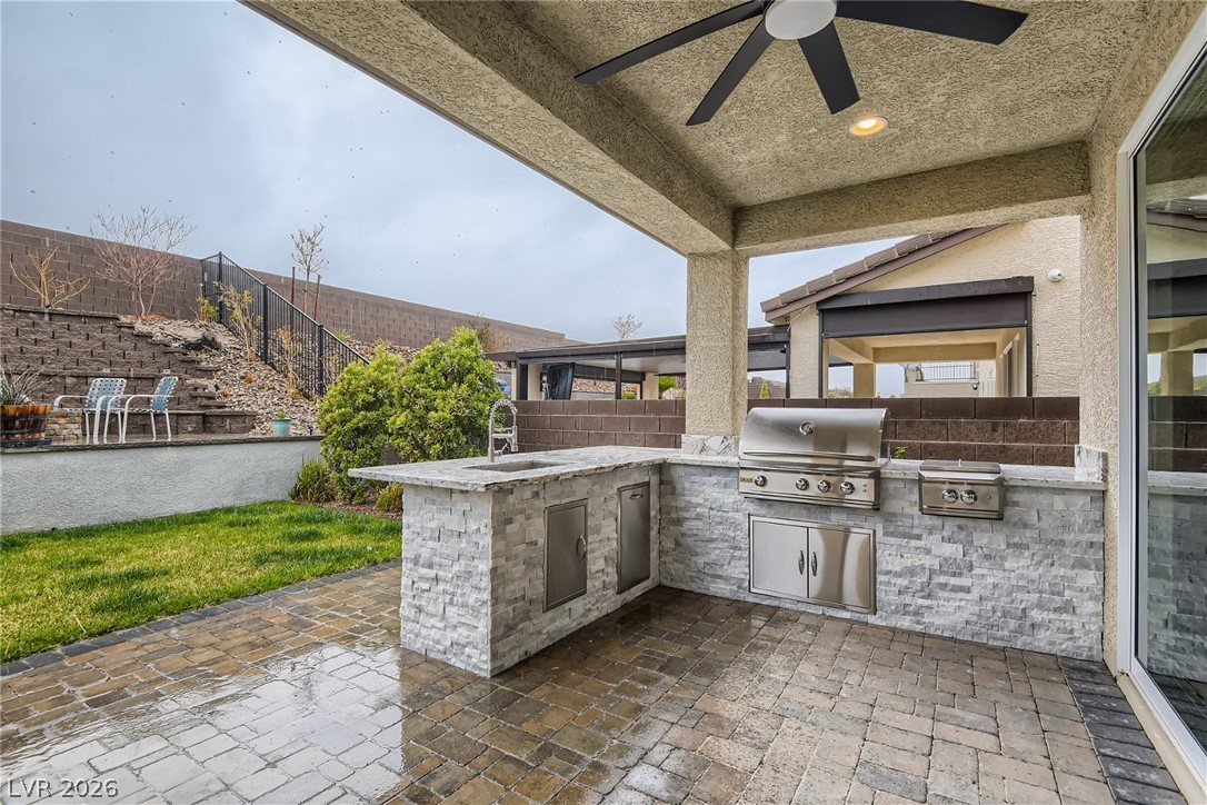 4631 Amazing View Street Las Vegas, NV 89129 - Photo 21 of 33 An inviting outdoor kitchen area with a built-in grill offers an ideal setting for al fresco dining.