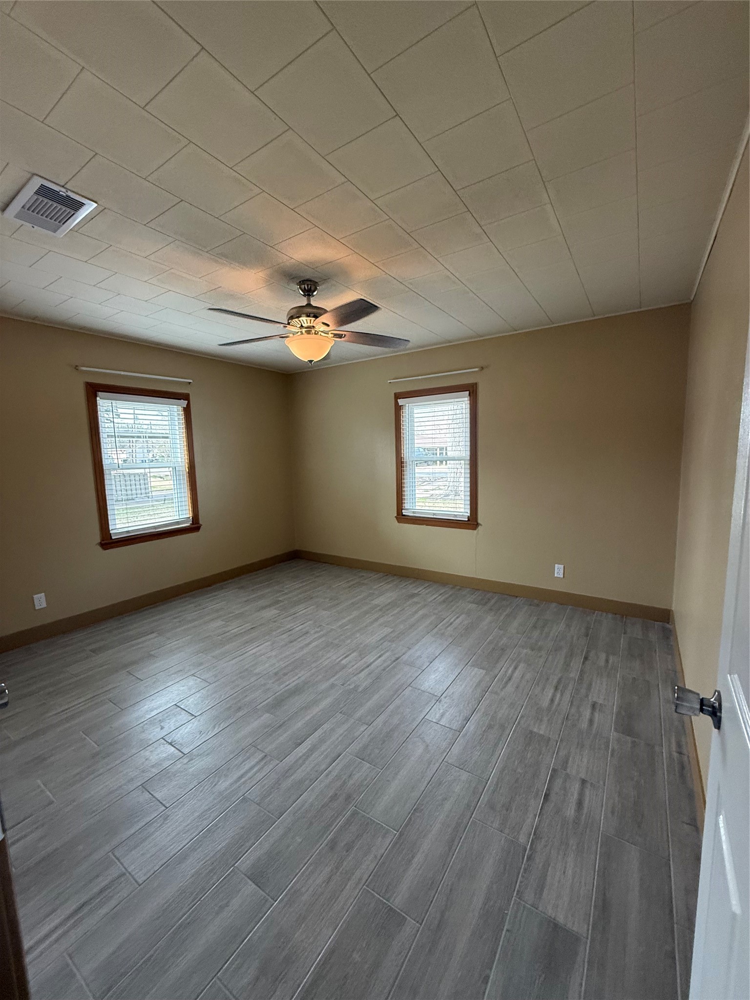 706 Alice Street Sweeny, TX 77480 - Photo 7 of 8 a view of an empty room with wooden floor and a window