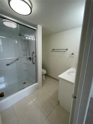 a bathroom with a shower and toilet