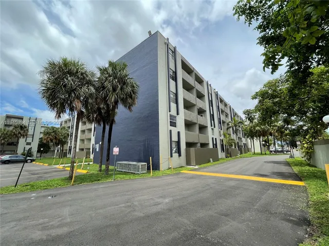 a view of a tall building with a palm trees