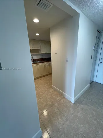 a view of a hallway to kitchen