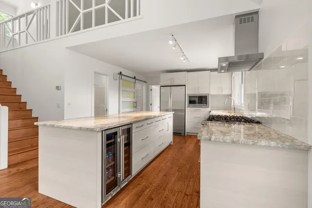 a large kitchen with a stove and a sink