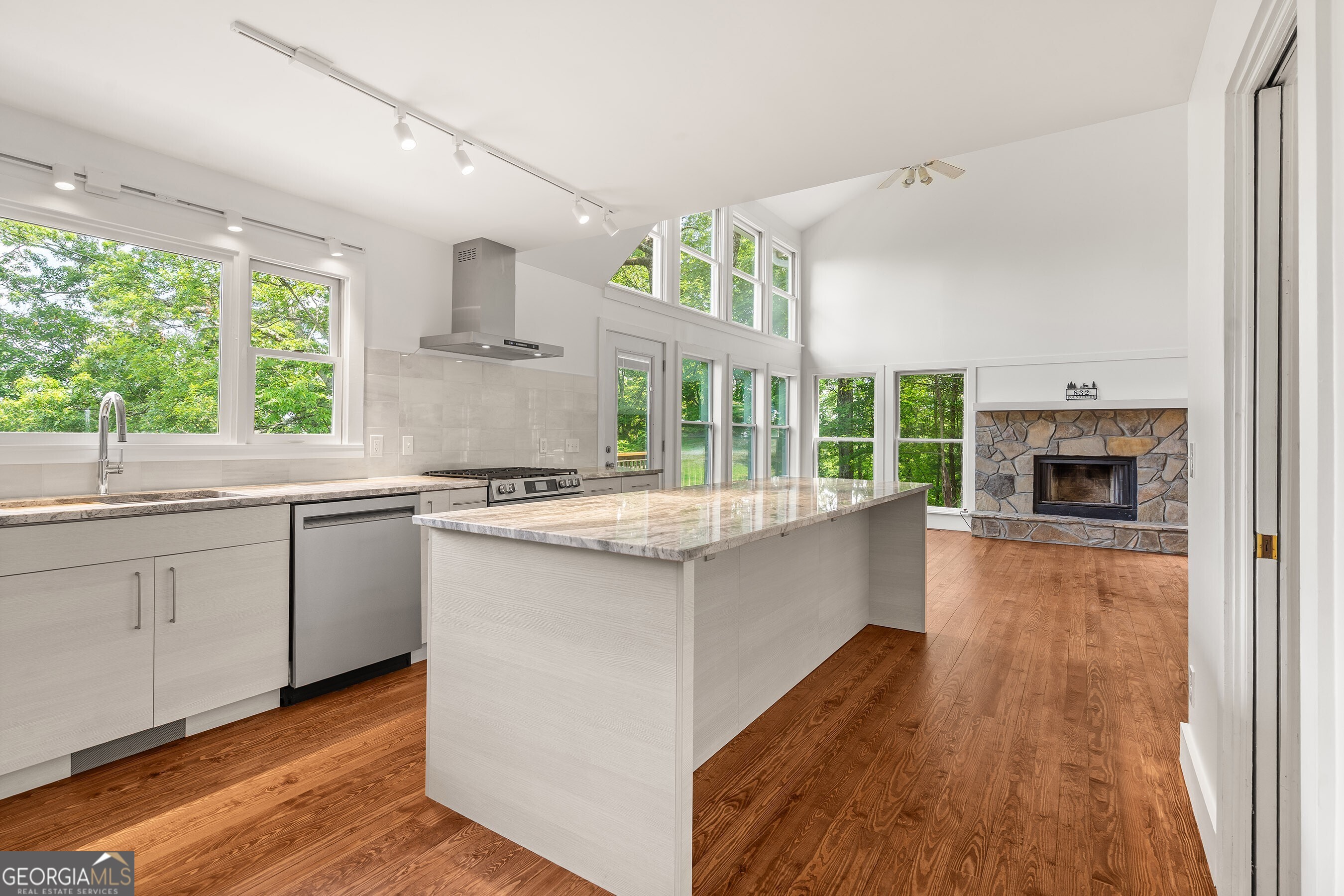 832 Round Top Drive Clayton, GA 30525 - Photo 14 of 42 a kitchen with stainless steel appliances granite countertop a stove and a sink