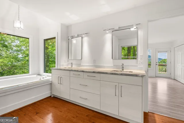 a bathroom with a bathtub and next to a window