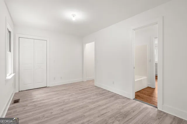 a bathroom with a granite countertop sink toilet and mirror
