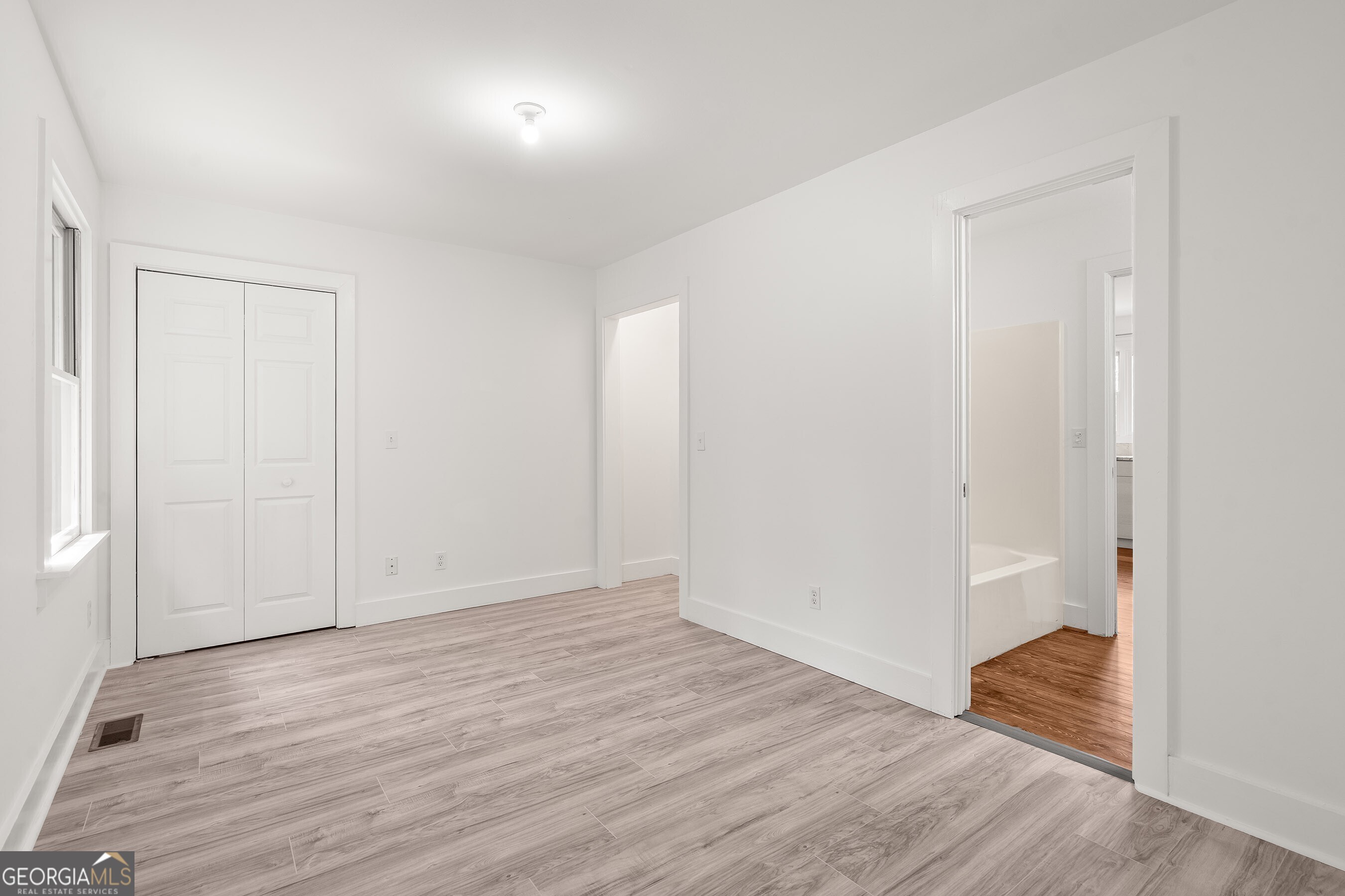 832 Round Top Drive Clayton, GA 30525 - Photo 22 of 42 an empty room with wooden floor & windows