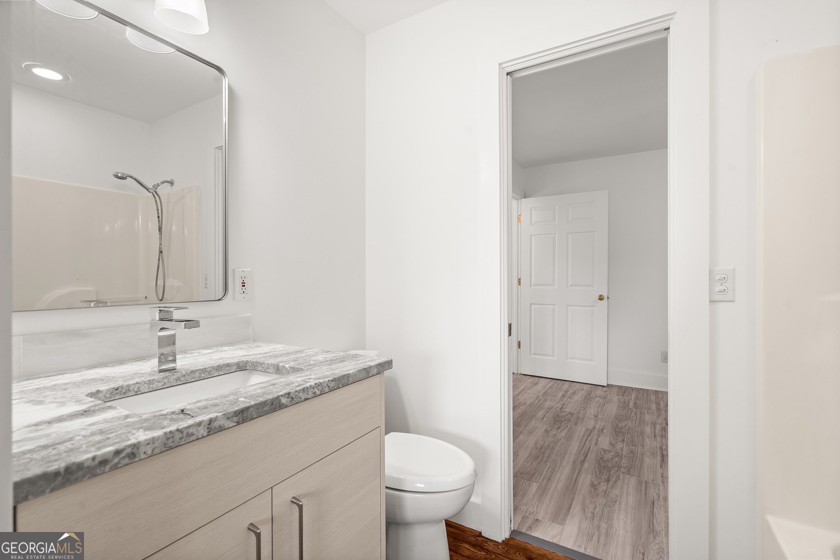 832 Round Top Drive Clayton, GA 30525 - Photo 23 of 42 a bathroom with a granite countertop sink toilet and mirror