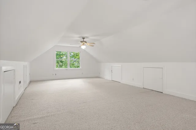 an empty room with chandelier fan