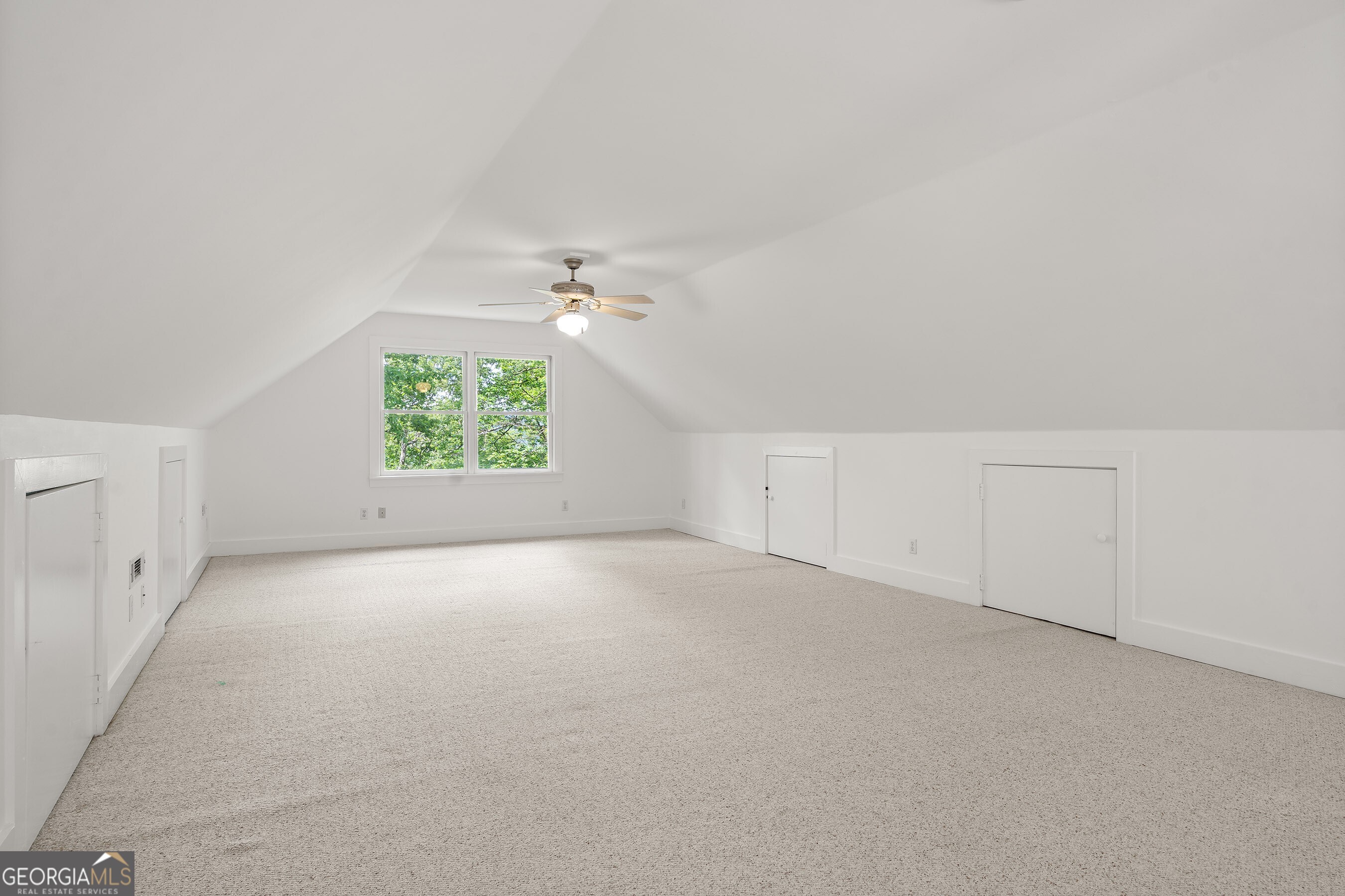 832 Round Top Drive Clayton, GA 30525 - Photo 25 of 42 an empty room with windows and chandelier fan