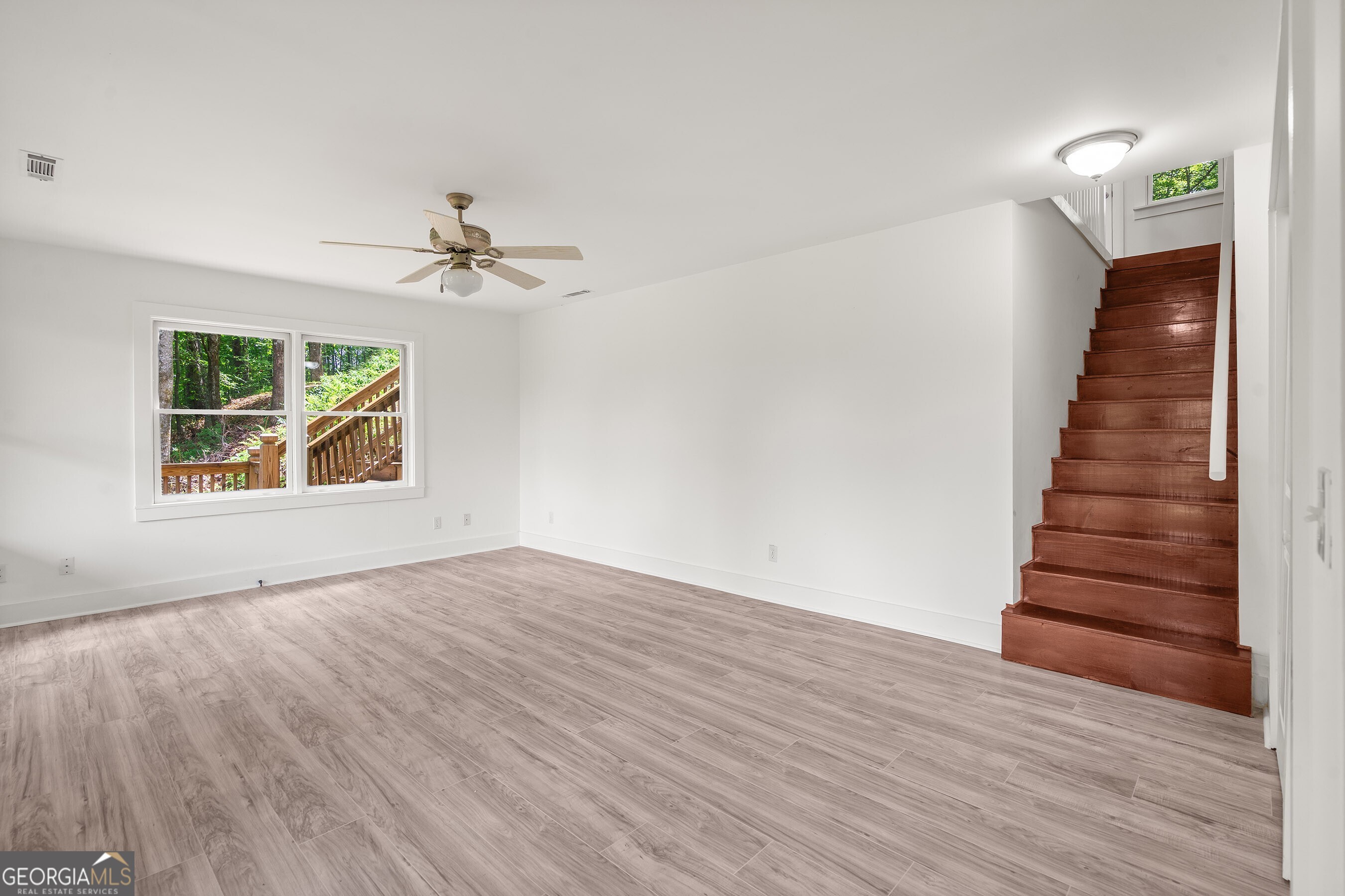 832 Round Top Drive Clayton, GA 30525 - Photo 27 of 42 wooden floor in an empty room with a window