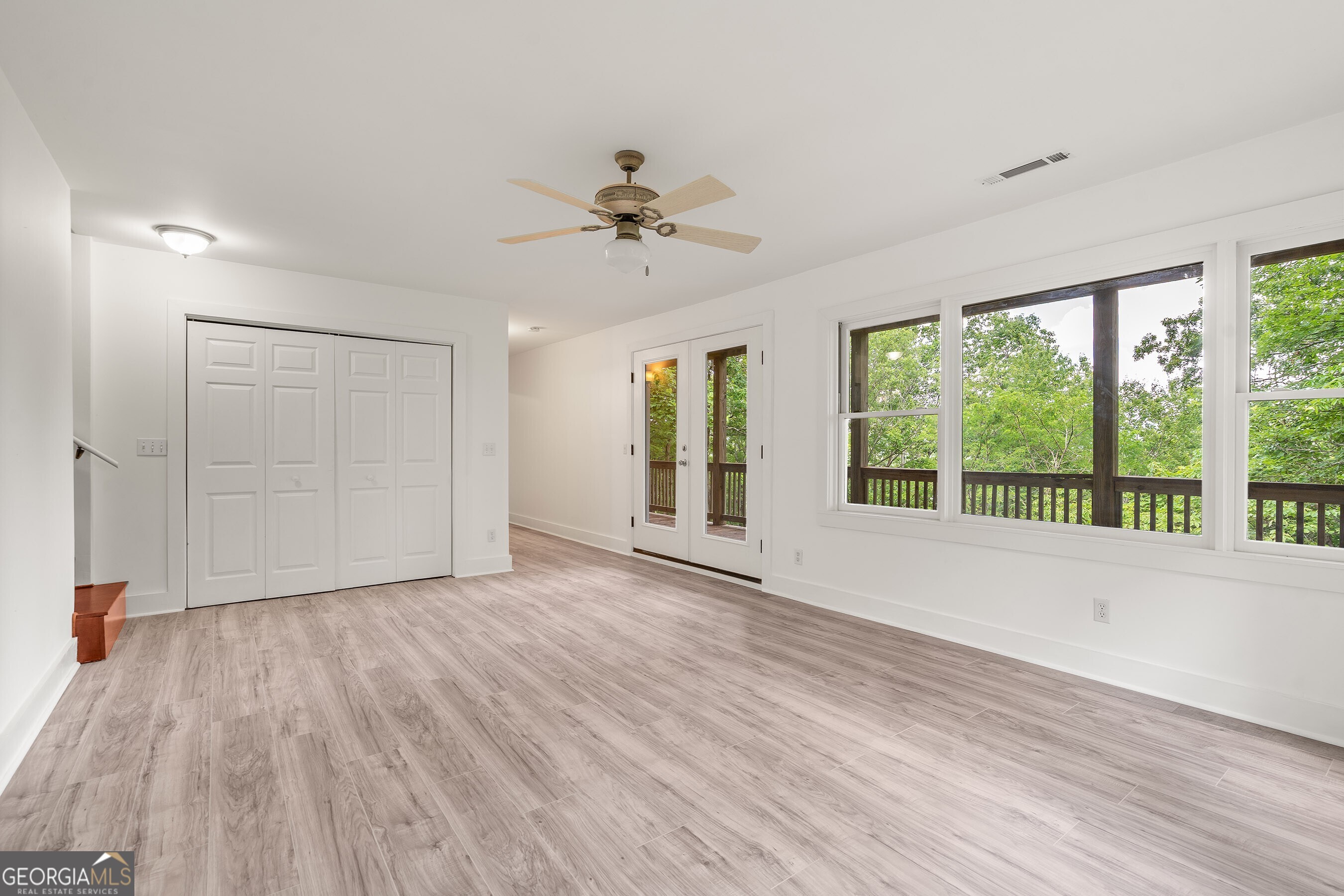 832 Round Top Drive Clayton, GA 30525 - Photo 28 of 42 a view of an empty room with a window and wooden floor