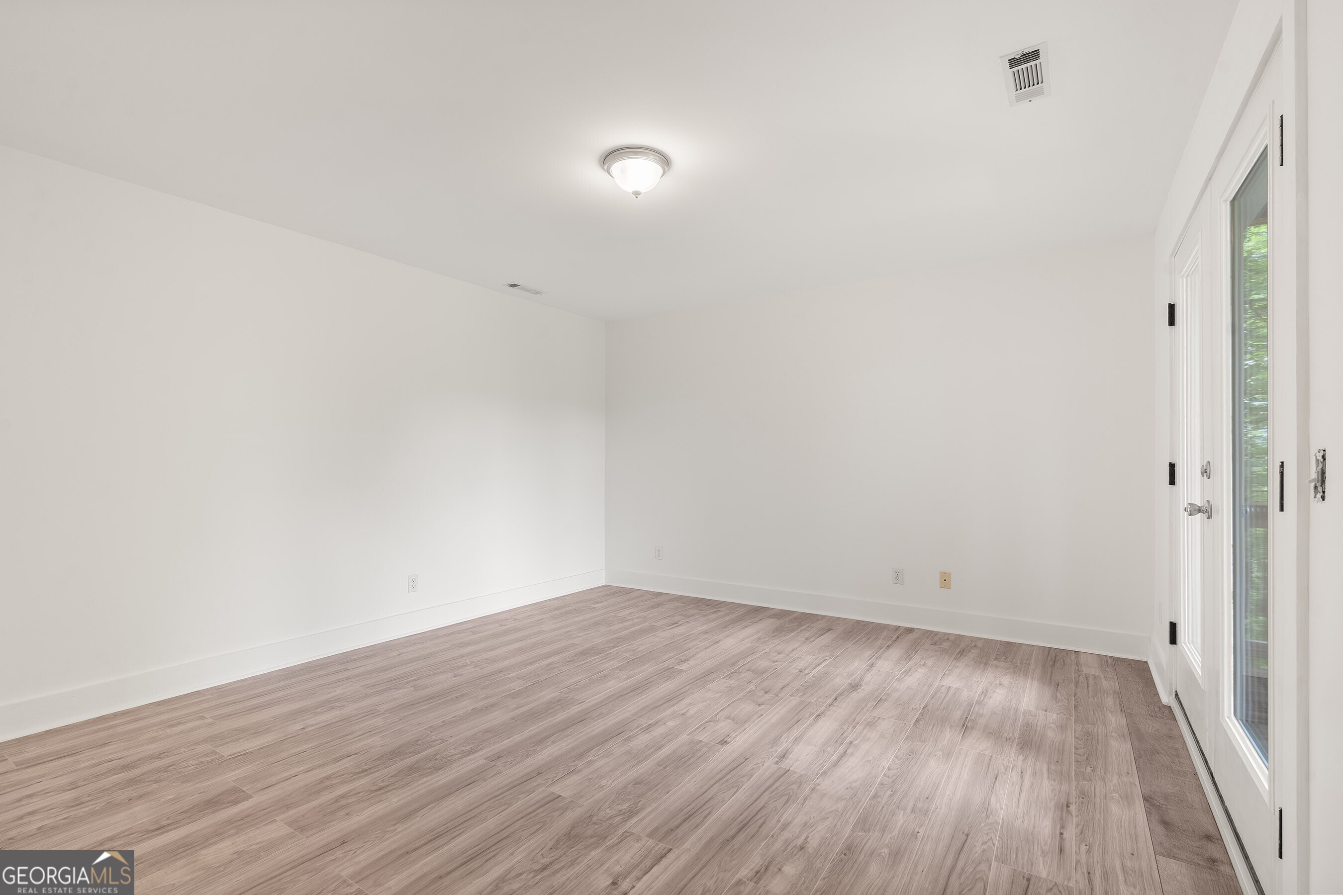 832 Round Top Drive Clayton, GA 30525 - Photo 31 of 42 a view of an empty room with wooden floor and a window