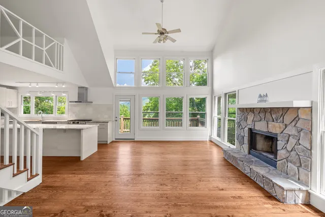 a open kitchen with white cabinets and outdoor space