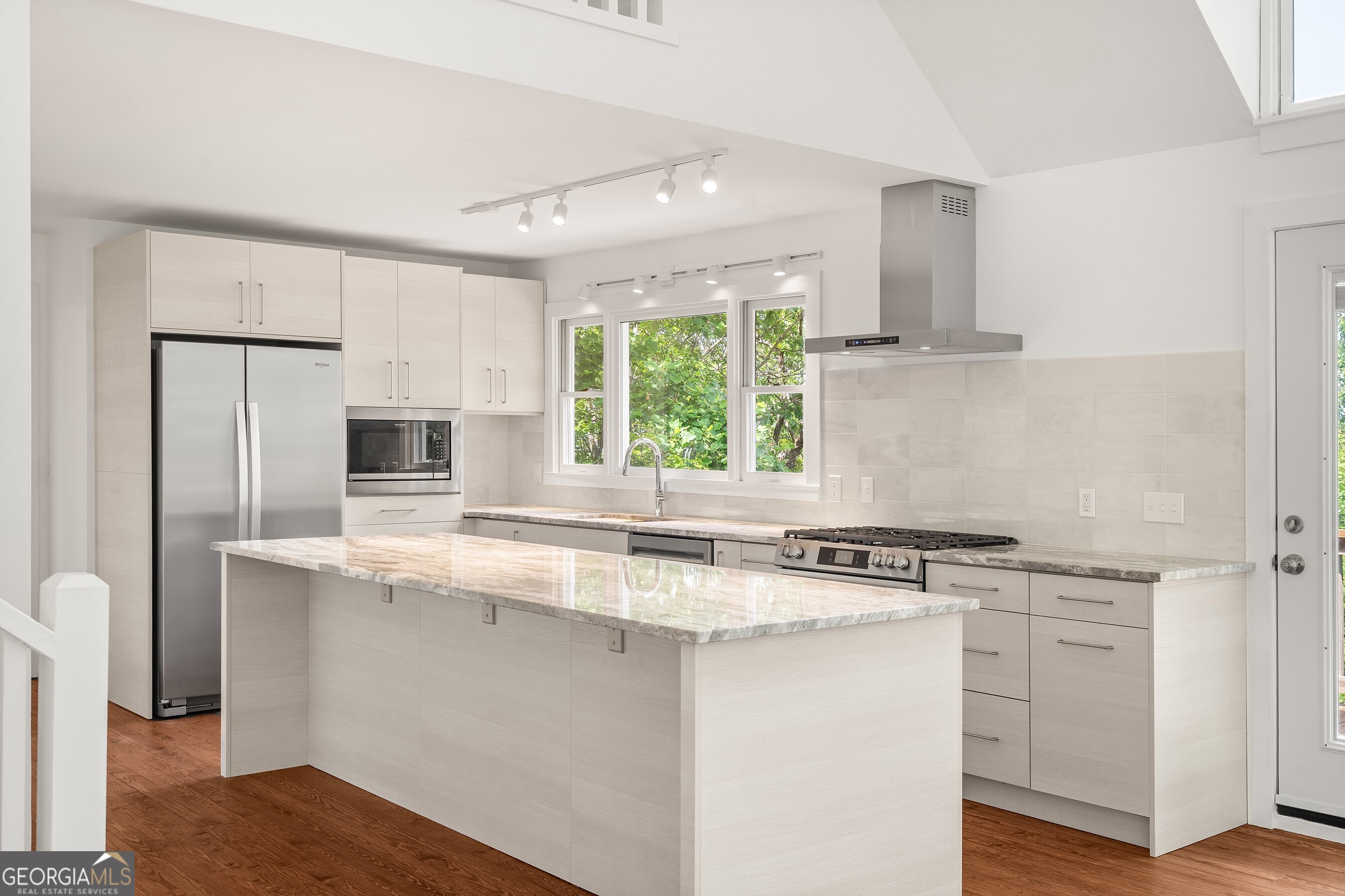 832 Round Top Drive Clayton, GA 30525 - Photo 7 of 42 a kitchen with stainless steel appliances granite countertop a sink stove and refrigerator