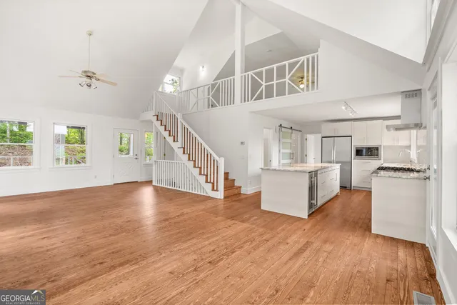a view of kitchen and hall with wooden floor