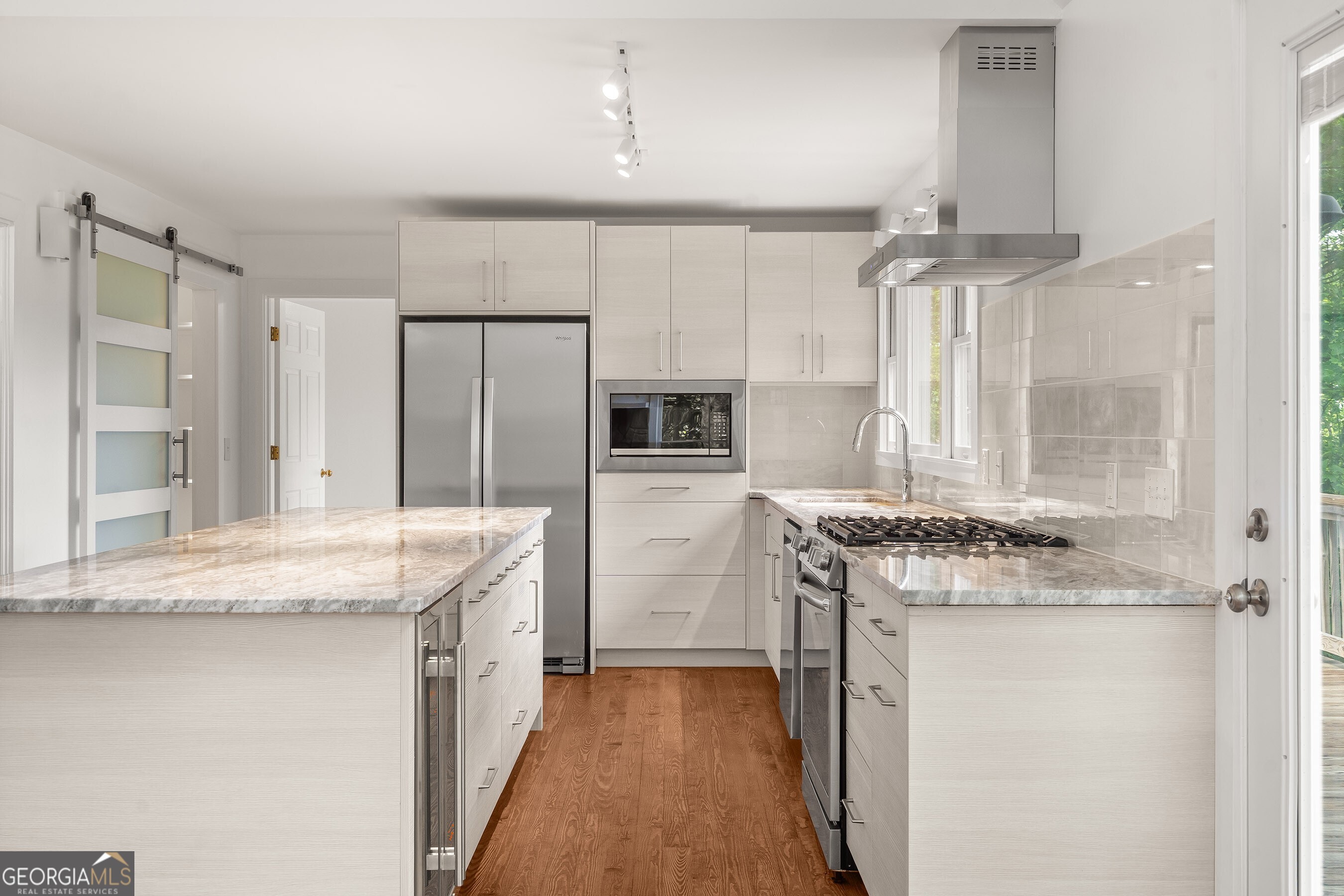 832 Round Top Drive Clayton, GA 30525 - Photo 10 of 42 a kitchen with granite countertop a sink stove and refrigerator