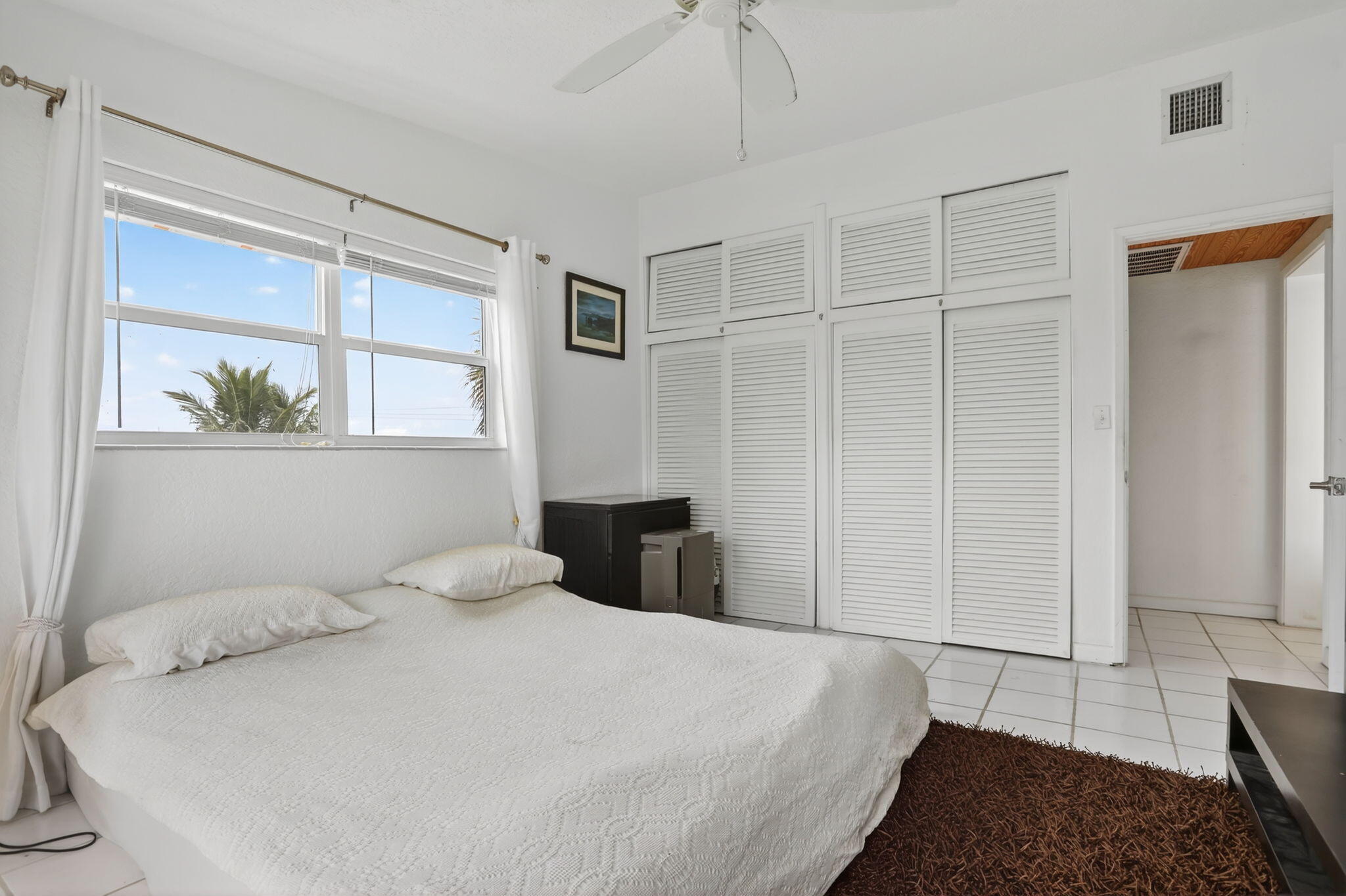 1043 Hillsboro Mile, Unit 22C Hillsboro Beach, FL 33062 - Photo 13 of 53 a bedroom with a large bed and a window