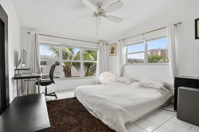 a bedroom with furniture and a window