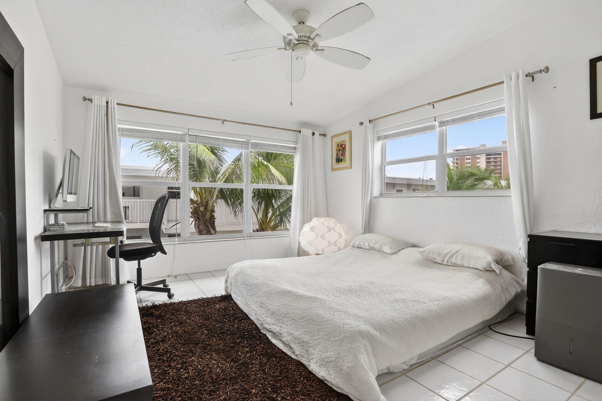 1043 Hillsboro Mile, Unit 22C Hillsboro Beach, FL 33062 - Photo 14 of 53 a bedroom with a bed and a chandelier