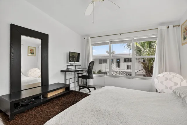 a bedroom with a bed and a mirror