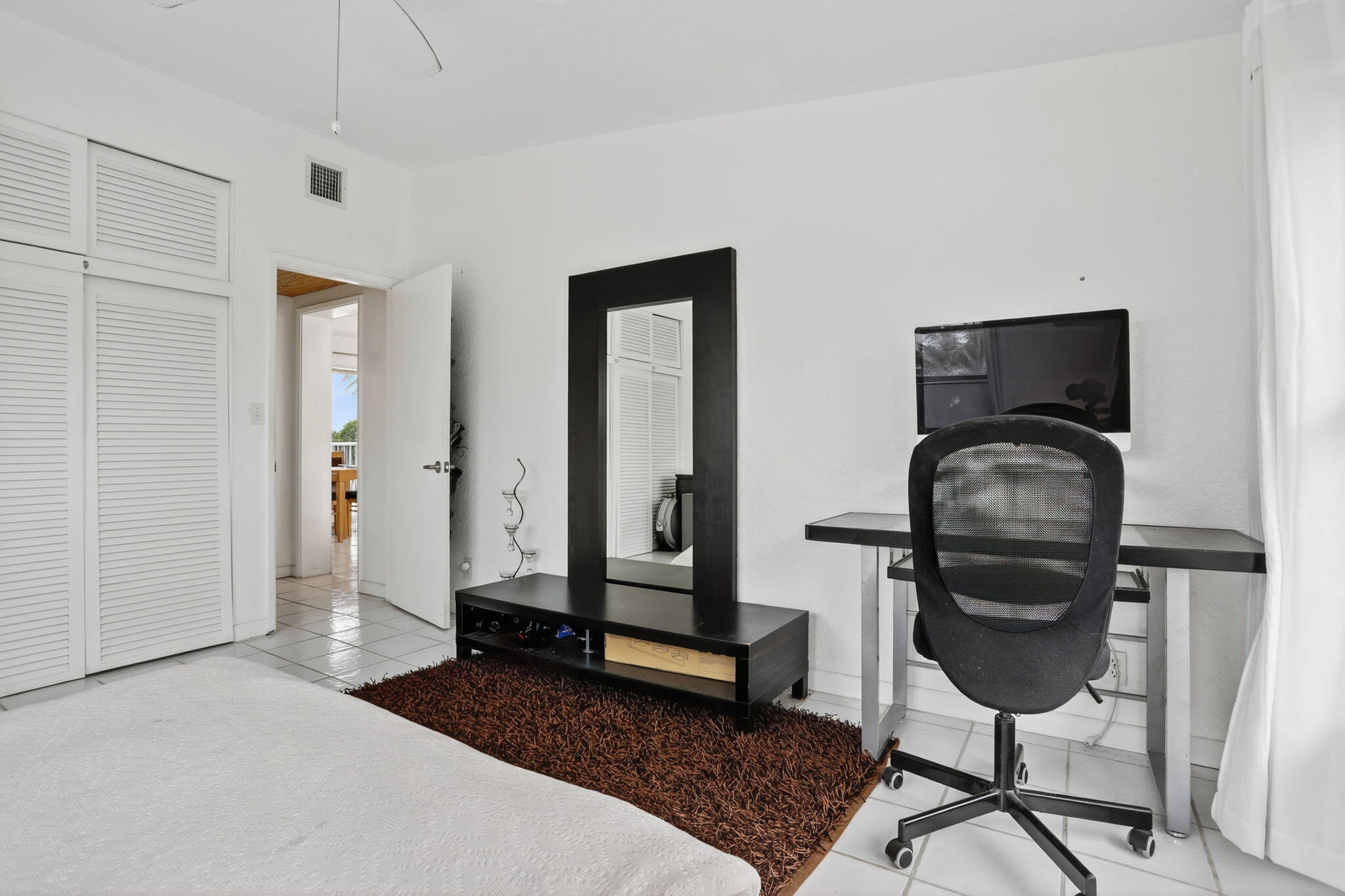 1043 Hillsboro Mile, Unit 22C Hillsboro Beach, FL 33062 - Photo 16 of 53 a bedroom with a bed and a mirror