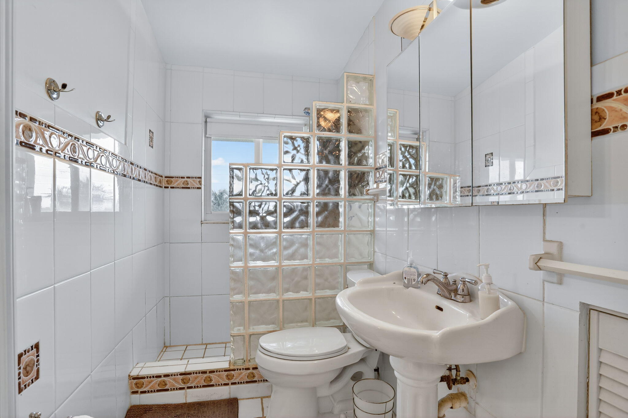 1043 Hillsboro Mile, Unit 22C Hillsboro Beach, FL 33062 - Photo 17 of 53 a bathroom with a sink a toilet and mirror