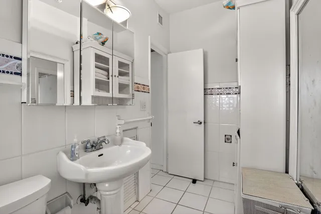 a room with a cabinets and washer