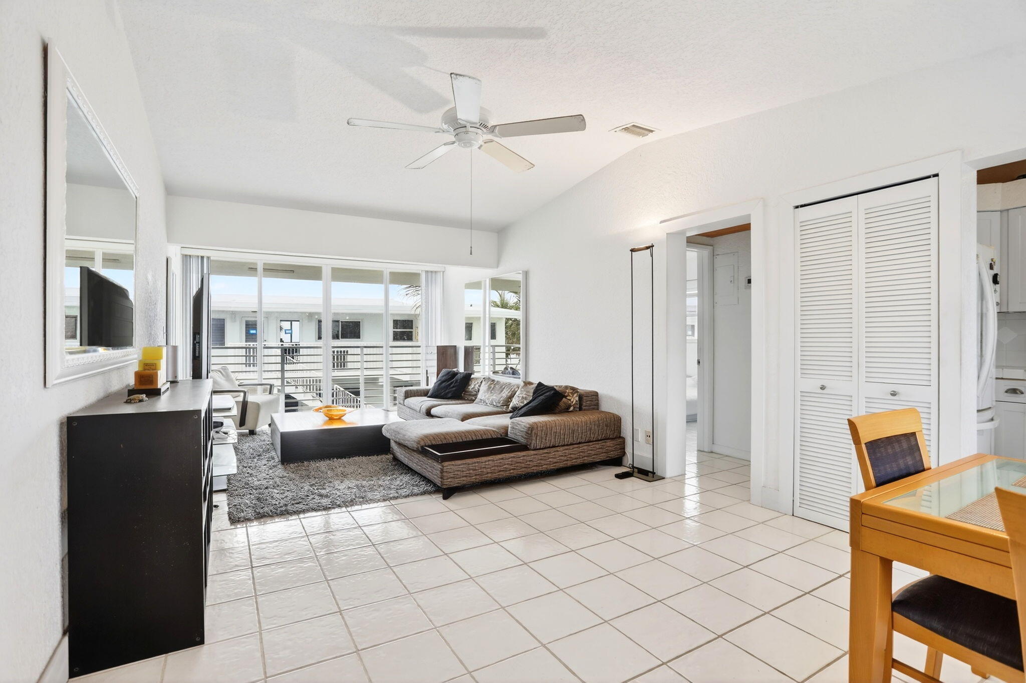 1043 Hillsboro Mile, Unit 22C Hillsboro Beach, FL 33062 - Photo 2 of 53 a living room with furniture and a flat screen tv