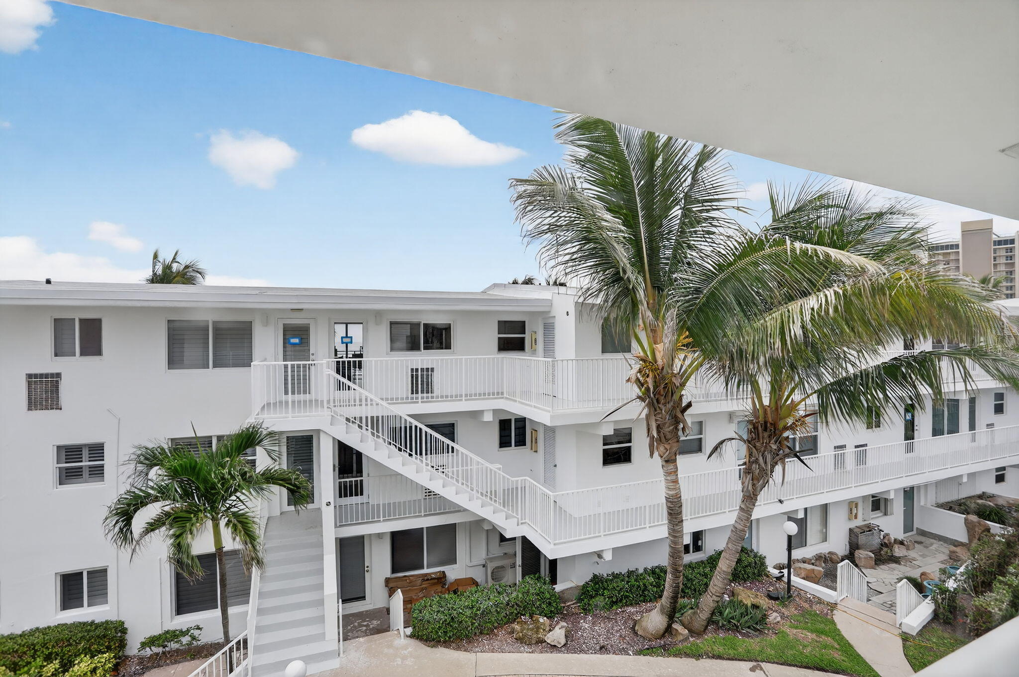 1043 Hillsboro Mile, Unit 22C Hillsboro Beach, FL 33062 - Photo 24 of 53 a front view of a house with a palm tree