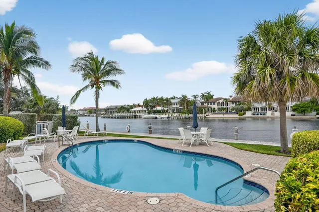 a view of a house with pool and chairs