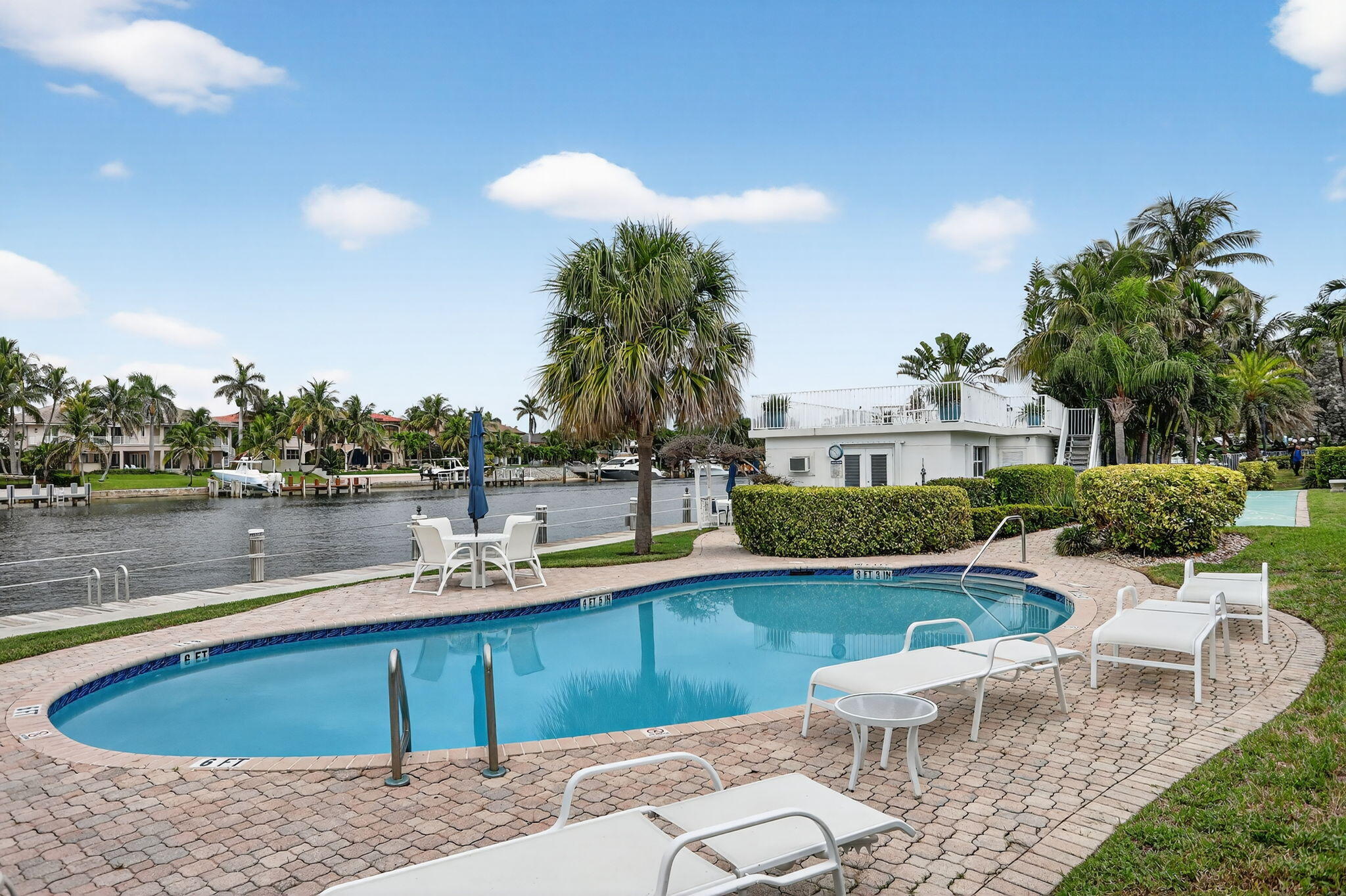1043 Hillsboro Mile, Unit 22C Hillsboro Beach, FL 33062 - Photo 26 of 53 a view of a house with pool and chairs