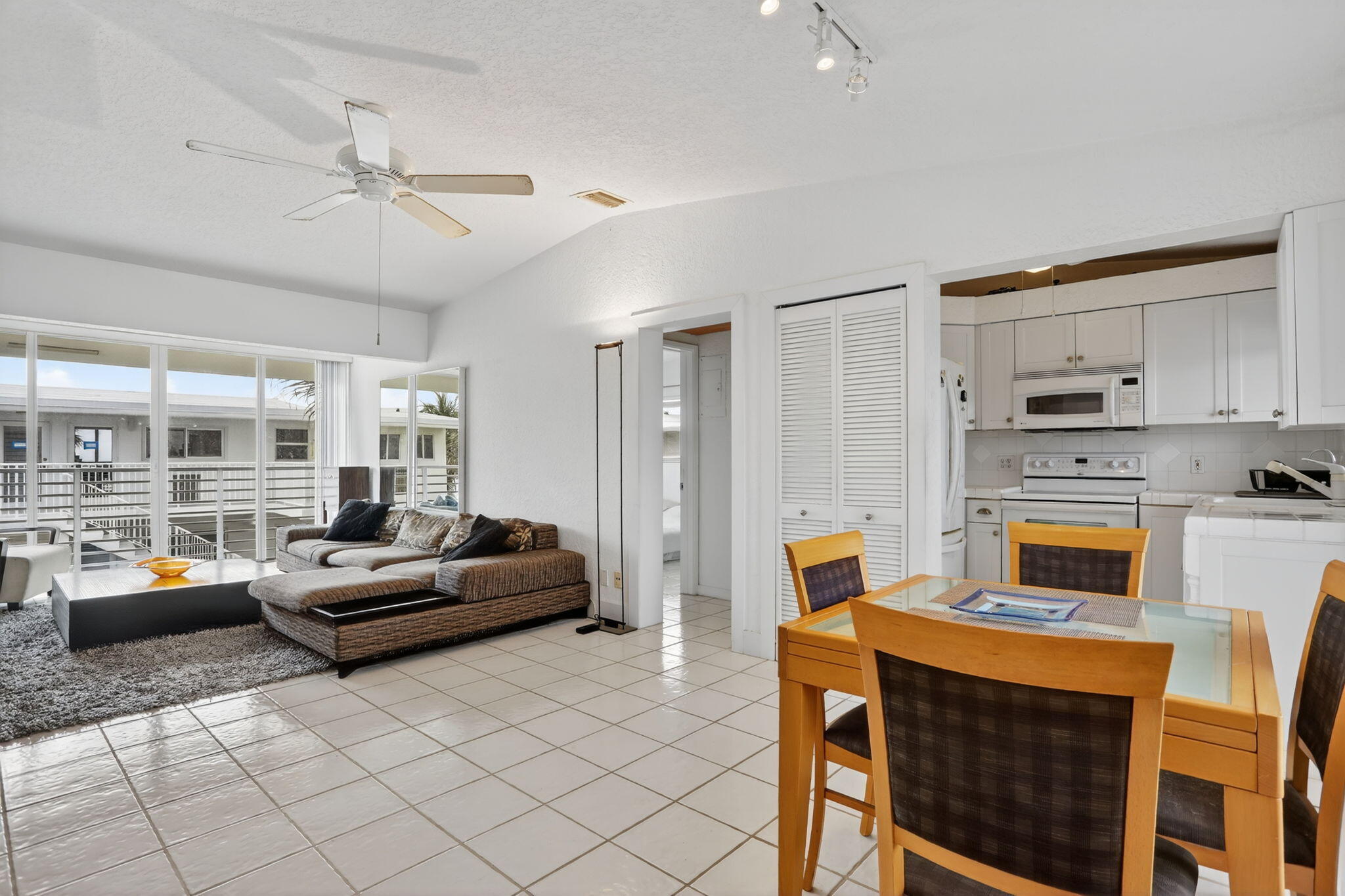 1043 Hillsboro Mile, Unit 22C Hillsboro Beach, FL 33062 - Photo 3 of 53 a kitchen with stainless steel appliances kitchen island granite countertop a table chairs and a refrigerator