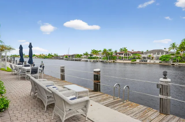 a view of a lake with couches chairs and city view