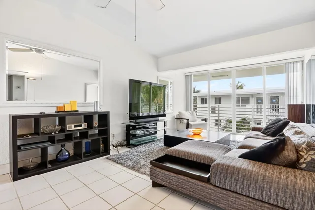 a living room with furniture and floor to ceiling windows